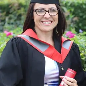 Cathryn Hurd holding a degree scroll