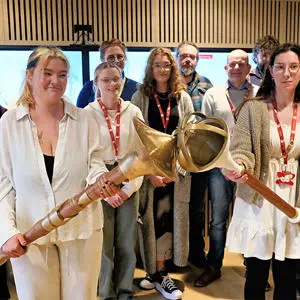 The students holding two prototypes of their mace designs