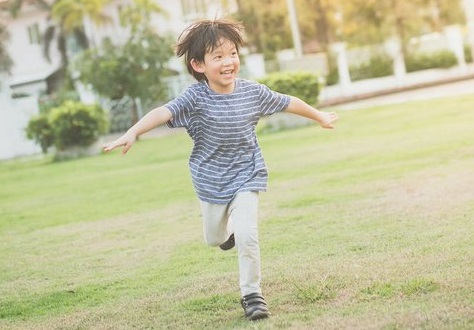 A boy running in a park