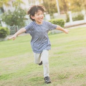A boy running in a park