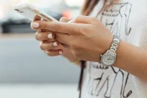 A close up of a woman's hands holding a mobile phone