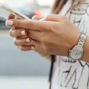 A close up of a woman's hands holding a mobile phone
