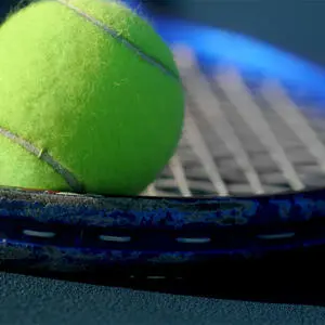 A tennis racket and ball