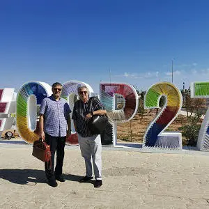 The Professors stood in front of giant COP27 letters