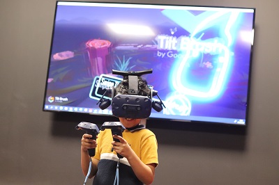 A boy wearing a VR headset and holding controllers