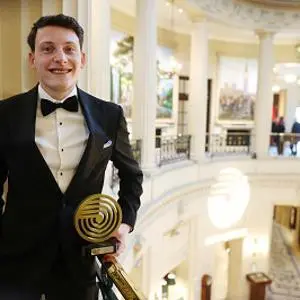 Dominic Gibbons photographed with his award