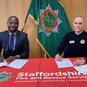 Dr Nana Agyeman and Chief Fire Officer Rob Barber signing the MOU