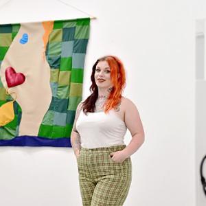 Eve Travis in front of her work