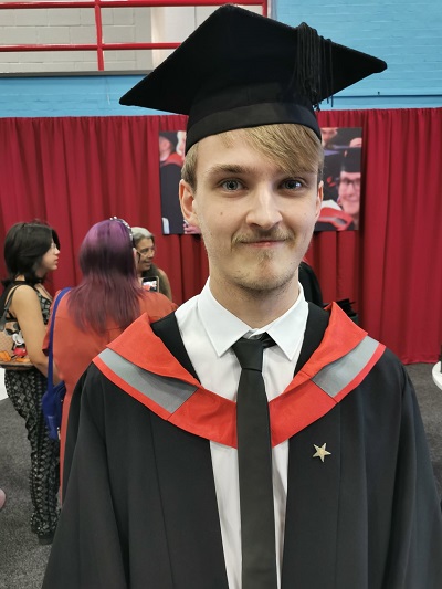 Fergus Griggs pictured in his cap and gown at graduation