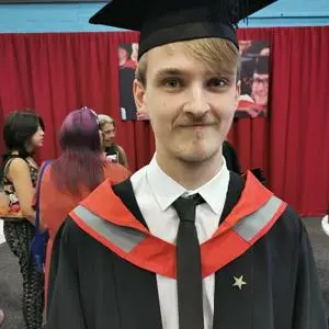 Fergus Griggs pictured in his cap and gown at graduation