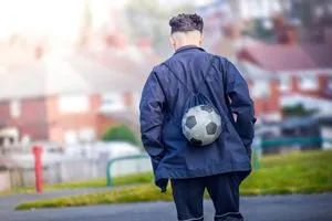 Young man walking away from the camera