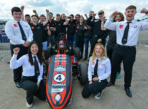 Staffordshire University students pictured surrounding their racing car