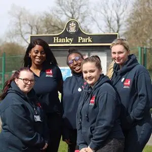 Education Studies student in front of the Hanley Park sign