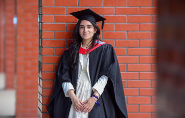 Huda Fatima in her graduation cap and gown