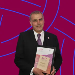 Ian Davies MBE, pictured receiving his Biomedical Scientist of the Year Award in 2023