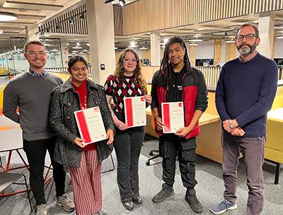 The bursary winners photographed holding their certificates