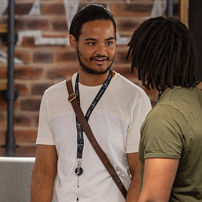 A male student speaking to another male student in Reload Café.