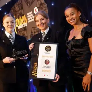 two female police officers being presented with an award