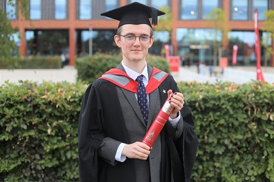 Joseph Findlay in his graduation robes receiving his award