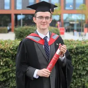 Joseph Findlay in his graduation robes receiving his award