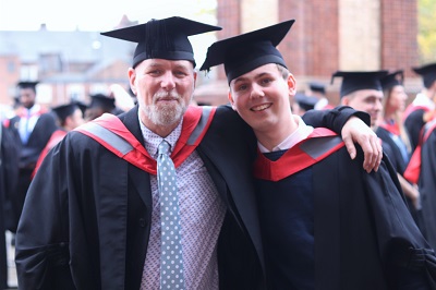 Kelvin and Chris pictured in their graduation robes