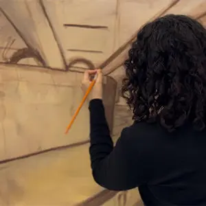 Student Lii Smith working on their artwork