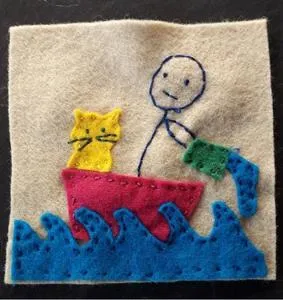 Felt embroidery of a stick figure and two cats in a red boat riding blue waves.