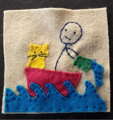 Felt embroidery of a stick figure and two cats in a red boat riding blue waves.