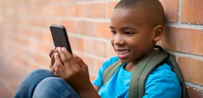 A young boy using a mobile phone