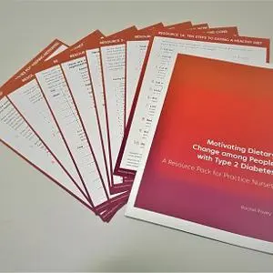 Red booklet and worksheets titled 'Motivating dietary change among people with Type 2 Diabetes.'