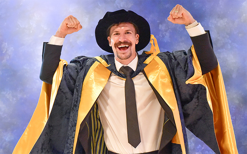 Nathan Heaney in his honorary doctor cap and gown