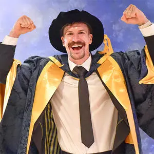 Nathan Heaney in his honorary doctor cap and gown