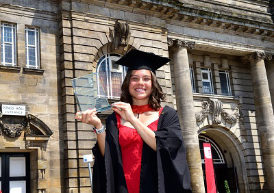 Olivia Taylor holding an award for gaining the highest marks on her course