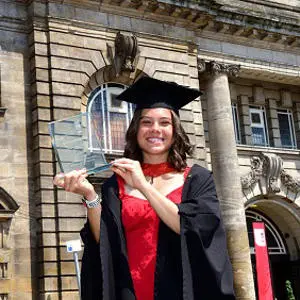 Olivia Taylor holding an award for gaining the highest marks on her course