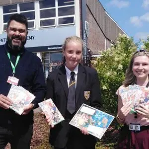 School pupils holding the Book of Nonsense