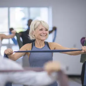 An older woman exercising with resistance bands