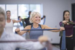 An older woman exercising with resistance bands