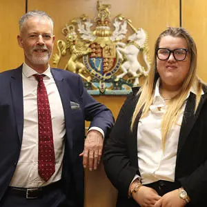 Peter Heath and Jessica Sample stood in a mock law court