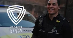 Smiling police officer beside a patrol car with the words 'Protect, Learn, Serve.'