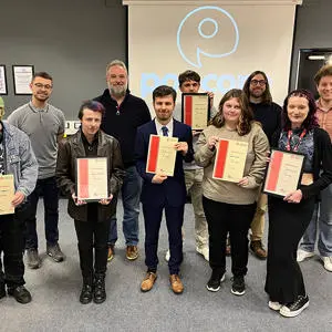 The group of students holding certificates
