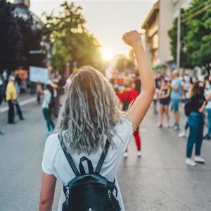 An image of a protester with their hand in the air