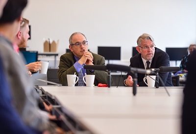 Men sat at a tablefor a discussion.