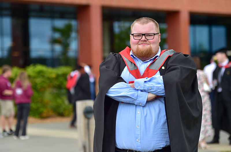 Rowan Simpson in his graduation cap and gown