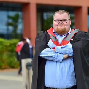 Rowan Simpson in his graduation cap and gown