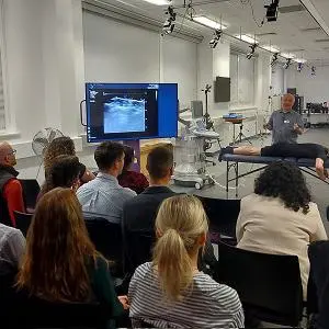 People sat watching a demonstration in the lab