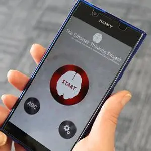 Hand holds a smartphone displaying the Smarter Thinking app with a large red 'START' button.