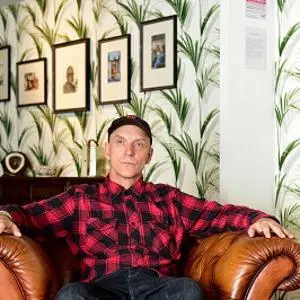 Stephen Lawson in front of his photos