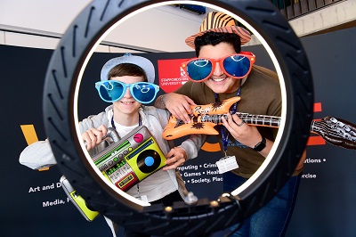 Two males celebrating results on 360 selfie booth