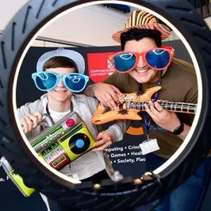 Two males celebrating results on 360 selfie booth