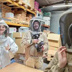 Taylor Smith (right) and course mates in beekeeping suits
